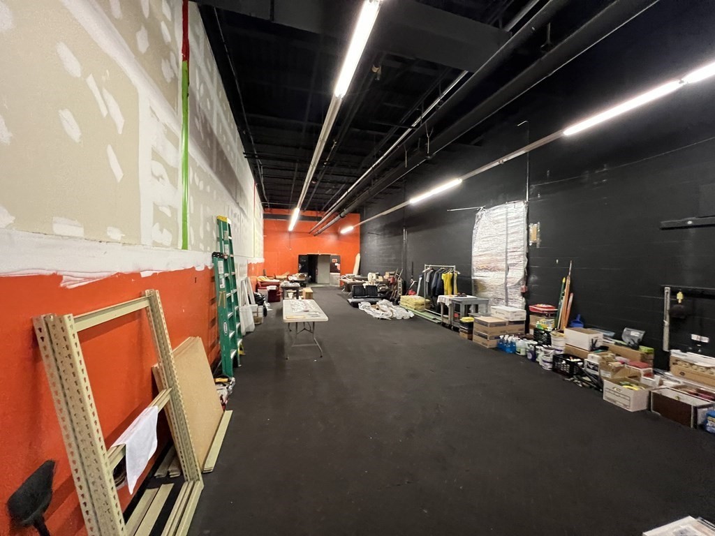 The inside of a retail space with lots of construction items and supplies scattered around.