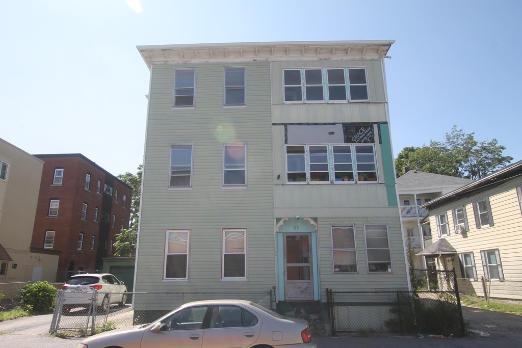 three story residential home, light green